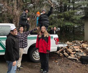 Newcastle firefighter Jake Abbot and a group of Lincoln Academy students load up a truck with firewood before making an emergency delivery to a Newcastle resident who is participating in the Community Housing Improvement Programs annual Home Heating Assistance Program. (Courtesy photo)
