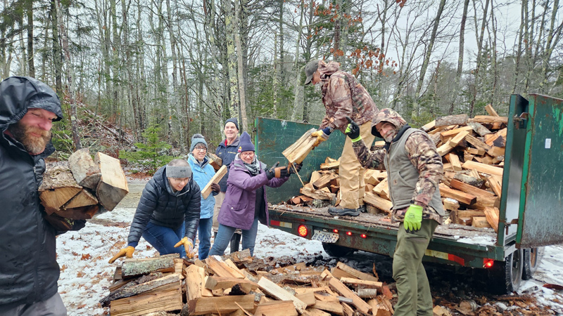 Volunteers from the Twin Villages Church in Damariscotta help deliver a load of firewood recently  The church members are a few of the many local volunteers who help CHIP deliver resources to people in need in the community. (Photo courtesy Community Housing Improvement Project)