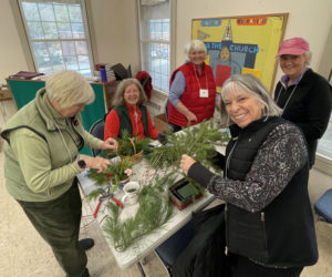 Sandy Besecker, Debbie Lorenson, Robin Grant, Tina Sedney and Brenda Lacombe, socialize while creating holiday baskets at the December meeting of the Garden Club of Wiscasset. (Photo courtesy Jan Flowers)