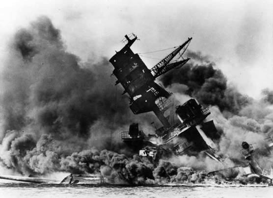 On fire and sinking, the U.S.S. Arizona lists badly to one side after being struck by Japanese bombs during the attack on Pearl Harbor Dec. 7, 1941. The ship remains at the bottom of the harbor where it is a permanent memorial to the servicemen who lost their lives in the attack. (Courtesy photo)