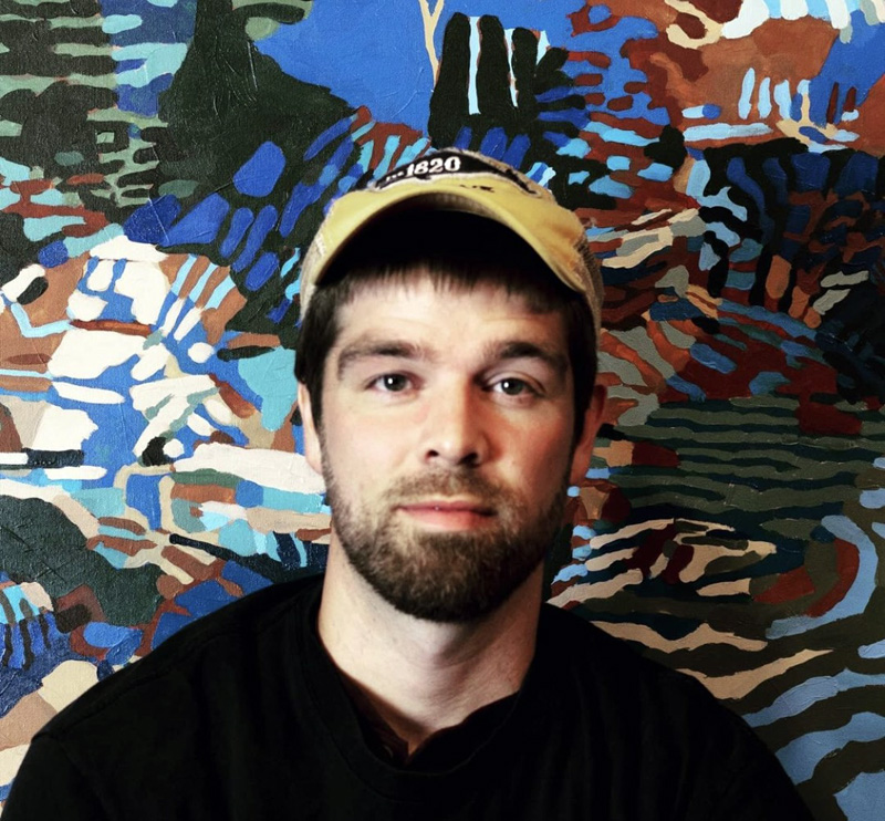 Alna artist Graham Walton stands in front of a painting at the Salt Pond Studio in Friendship in May 2021. Walton works mostly with acrylic paint to create vivid and vibrantly-colored paintings of Maine's landscape with his own unique twist. (Photo courtesy Graham Walton)