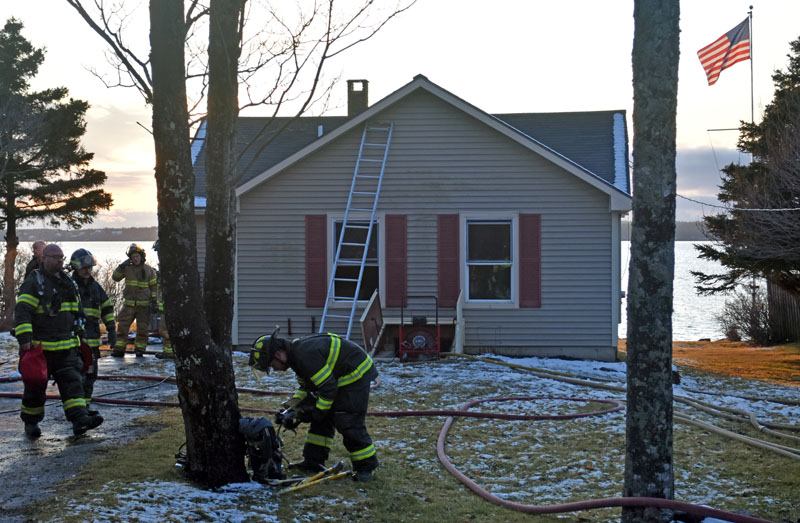 Firefighters prepare to clear the scene of a Bristol structure fire on the afternoon of Saturday, Jan. 7. The interior of the home's first floor was damaged by high temperatures. (Elizabeth Walztoni photo)