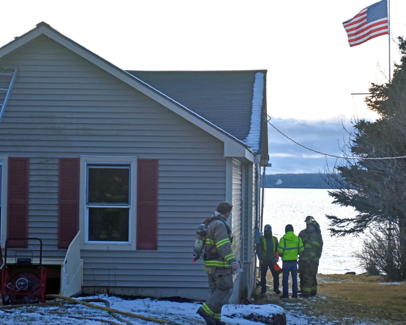 Firefighters and Spectrum employees discuss an electrical box on the side of a home in Bristol that caught fire the afternoon of Saturday, Jan. 7 after an electrical surge. (Elizabeth Walztoni photo)