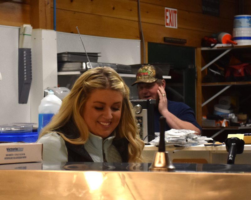 Amy and Gregory Simmons, of Friendship, work together behind the counter of their new business, Simmons Seafood Market, at 49 Main St. in Damariscotta. The market, which will celebrate a grand opening on Feb. 3, is a project the Simmonses said they have enjoyed working on as a team. (Elizabeth Walztoni photo)