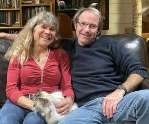 Jaja and Dave Martin relax at their self-built home in Bremen with their pet cat, Shackleton. After sailing the world for almost two decades, the Martin family arrived in Lincoln County in 2003 and found the community they were looking for. (Sherwood Olin photo)