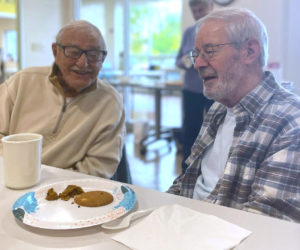 Pande Stevens (left) and Wally Silva enjoy conversation over lunch at the CLC YMCA in Damariscotta. Bring a healthy dish to share on the first Wednesday of every month and catch up with friends old and new during pot luck lunches for active, older adults. (Photo courtesy CLC YMCA)