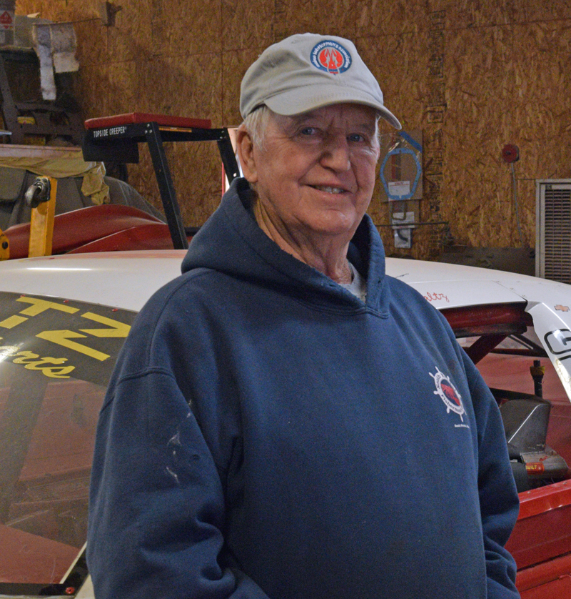 Longtime South Bristol Select Board member Chester Rice  stands by his race car in his Walpole shop on Monday, Feb. 6. After 26 years of service on the board, Rice is not running for reelection this March. (Evan Houk photo)