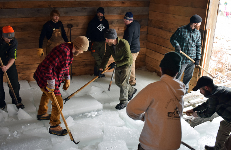 Volunteers corral and sort 250- to 300-pound ice blocks inside the Thompson Ice House in South Bristol during the 2019 ice harvest. This year the traditonal harvest will be held Sunday, Feb. 19. (LCN file photo)