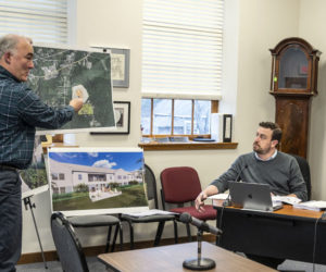 Civil engineer Stephen Bushey (left) presents a map showing the location of a planned development to interim Town Planner Michael Martone (center) and Damariscotta Planning Board Chair Jonathan Eaton during a meeting on Tuesday, April 11. A public hearing regarding the project is scheduled for Monday, May 1. (Bisi Cameron Yee photo)
