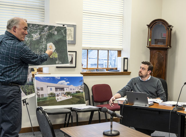 Civil engineer Stephen Bushey (left) presents a map showing the location of a planned development to interim Town Planner Michael Martone (center) and Damariscotta Planning Board Chair Jonathan Eaton during a meeting on Tuesday, April 11. A public hearing regarding the project is scheduled for Monday, May 1. (Bisi Cameron Yee photo)