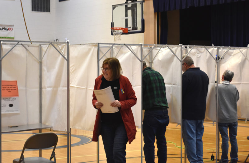 Jill Griffin heads to cast her ballot in Jefferson's annual town meeting by referendum at the Jefferson Village School gymnasium on Tuesday, April 18. (Elizabeth Walztoni photo)