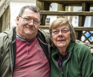 Robert and Phyllis Elwell pose for a photo in Damariscotta on Tuesday, April 18. The couple, who have been married for 24 years, have spent the last seven years caring for the flock of feral geese that have become an iconic fixture in Damariscotta Mills. (Bisi Cameron Yee photo)