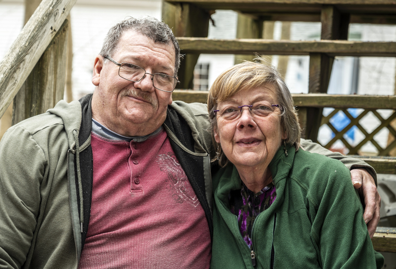 Robert and Phyllis Elwell pose for a photo in Damariscotta on Tuesday, April 18. The couple, who have been married for 24 years, have spent the last seven years caring for the flock of feral geese that have become an iconic fixture in Damariscotta Mills. (Bisi Cameron Yee photo)