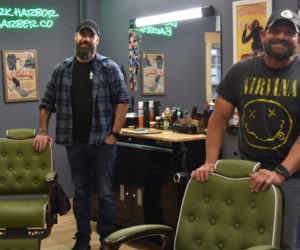 Apprentice Roger Grotton (left) and business partner D.J. Jones stand with their chairs at Dark Harbor Barber Co.'s new location at 904 Main St. in Waldoboro. Both were friends of business owner Sam Weldon and took on apprenticeships to join him in the business. (Elizabeth Walztoni photo)