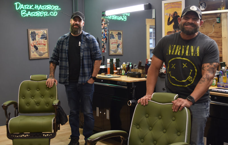 Apprentice Roger Grotton (left) and business partner D.J. Jones stand with their chairs at Dark Harbor Barber Co.'s new location at 904 Main St. in Waldoboro. Both were friends of business owner Sam Weldon and took on apprenticeships to join him in the business. (Elizabeth Walztoni photo)