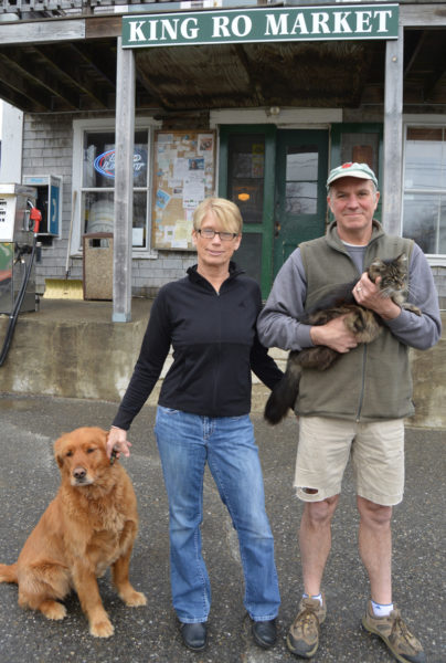 King Ro Market co-owners Lori Crook and B.J. Russell stand in front of the store with Calhoun the dog and Smokey the cat in 2016. (Maia Zewert photo, LCN file)