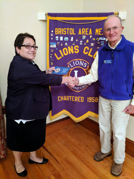 Maine 1st Vice District Gov. Tia Knapp presents Bristol Area Lion Walt Johansson with his 40-year pin commemorating his longtime membership in the International Lions Club in 2018. (LCN file photo)
