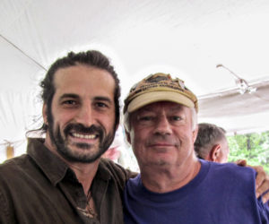 Adam Ezra (left) poses for a photo with Bobby Whear, owner of the Mill Pond Inn. The two have become good friends since Ezra first performed a benefit concert for the Damariscotta Mills Fish Ladder. (courtesy photo)