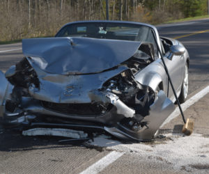 A Mazda convertible operated by James C. King, 71, of Cape Elizabeth, sits on Route 1 in Damariscotta after a head-on collision near the Belvedere Road intersection on Sunday, May 7. King told police he fell asleep while driving. (Sherwood Olin photo)