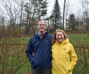 Scott and Sue Simpson, owners of Waldoberry Farm in Waldoboro, stand with their certified-organic Aronia berry bushes. The couple uses Aronia and other specialty berries in health-focused products developed and made by Sue Simpson. (Elizabeth Walztoni photo)