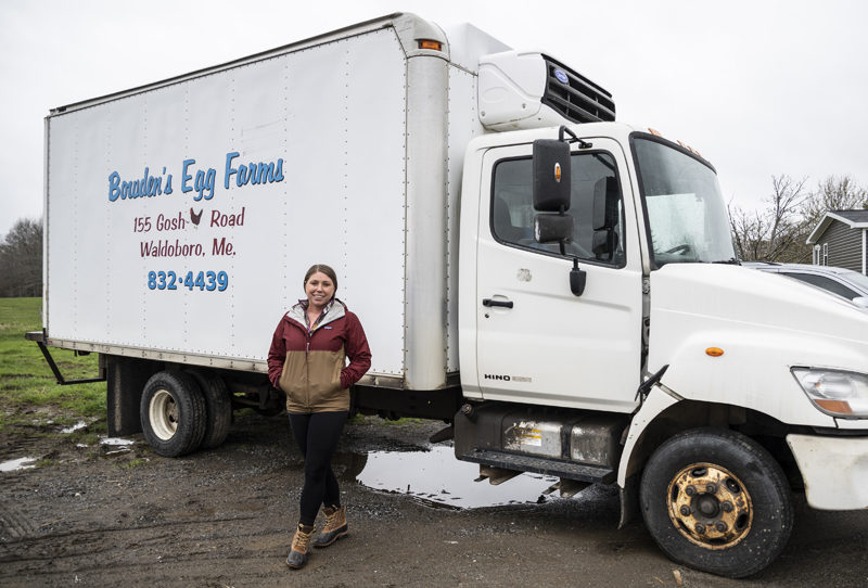 Jackie Gifford stands for a photo in front of her truck at Bowden's Egg Farm in Waldoboro on Thursday, May 4. Gifford started delivering for the farm before she finished high school and 18 years later still loves bringing flats of fresh eggs to grocery stores, gas stations, restaurants, and inns throughout Maine. (Bisi Cameron Yee photo)