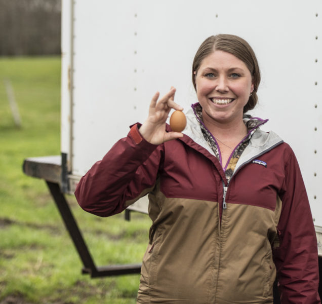 Jackie Gifford holds an egg for a photo at Bowden's Egg Farm in Waldoboro on Thursday, May 4. "Everyone knows me from the eggs," she said of her longtime job delivering for Bowden's Egg Farms. (Bisi Cameron Yee photo)