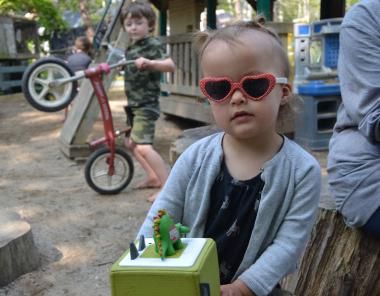 Gwen Grinnell, daughter of Clara and Eamon Grinnell, lets her inner rock star shine as she listens to music at Harbor Day Care in Bristol. Laurie Mahan, founder, focuses on getting the kids outside rather than using screens. (Johnathan Riley photo)