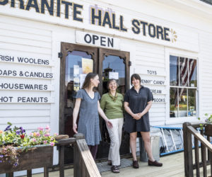 From left: Mary Boothby, Sarah Herndon and Jane Frost smile as they stand for a photo in front of Granite Hall Store in Round Pond on May 29. The Herndon family has owned the store for the last 40 years. (Bisi Cameron Yee photo)