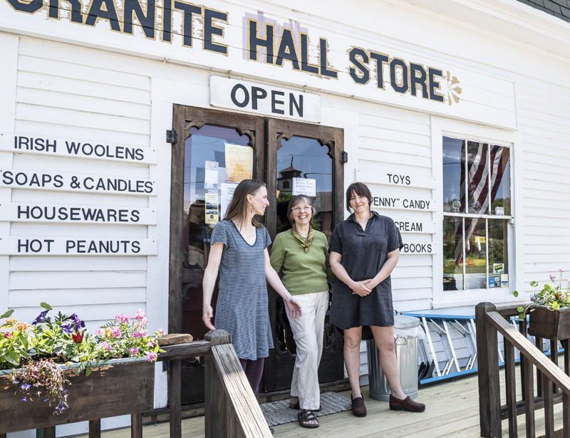 From left: Mary Boothby, Sarah Herndon and Jane Frost smile as they stand for a photo in front of Granite Hall Store in Round Pond on May 29. The Herndon family has owned the store for the last 40 years. (Bisi Cameron Yee photo)