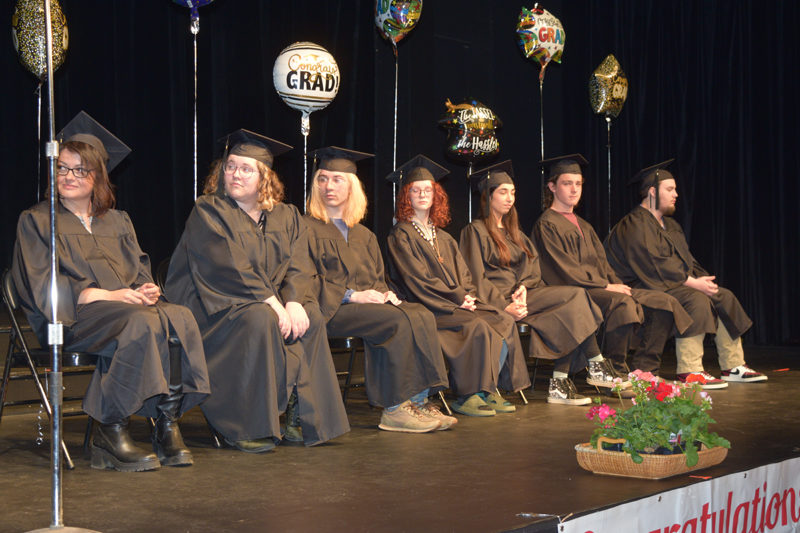 From left: Kimberly Weaver, Maeve Townsend, Brennan Townsend, Jasmin Tillson, Halena Stone, Quinton Esparza, and Connor Bickford prepare to graduate from the Central Lincoln County Adult Education program at Lincoln Theater on Tuesday, June 6. (Sherwood Olin photo)