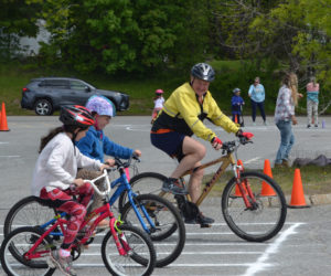 David DeFosses encourages students through one of the safety courses at Great Salt Bay Community School's bike rodeo on Thursday, May 25. The rodeo, organized by the school's bus drivers, teaches K-3 students about bike safety on and off the road. (Johnathan Riley photo)