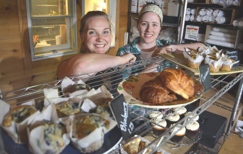 Crystal Berg (left) and Andrea "Annie" Leck stand behind a collection of Barn Door Baking Co. offerings in 2017. The longtime friends and business partners recently opened Barn Door Breakfast in downtown Damariscotta. (Maia Zewert photo, LCN file)