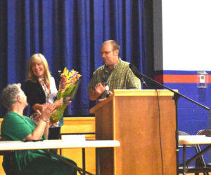 Damariscotta Deputy Town Clerk and Deputy Registrar Cheryl Pinkham receives flowers and a plaque from select board members in recognition of service to the town on Wednesday, June 14 at the open town meeting. (Elizabeth Walztoni photo)