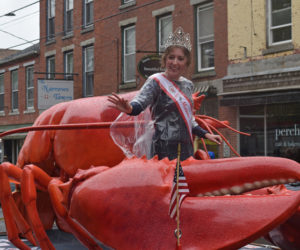 Maine Sea Goddess Olivia Dougherty waves to the crowd on Friendship Street in Waldoboro on Saturday, June 17 as part of the town's 250th anniversary parade. The full three-day celebration, which took over a year to plan, included a bean supper, car show, time capsule dedication, musical acts, a craft show, and more. (Dylan Burmeister photo)