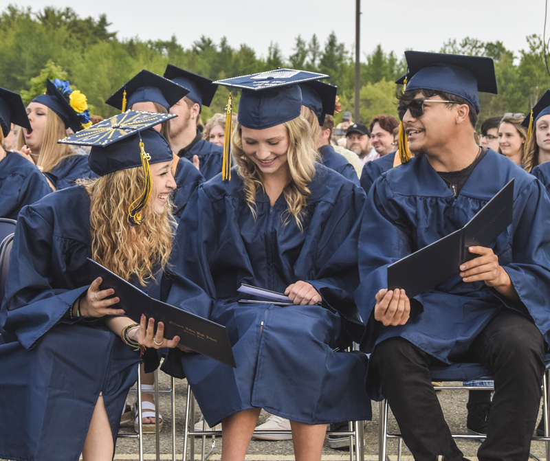 From left: Kaylee Daniel, Skylah Ward, Devin Secotte compare diplomas during the Medomak Valley High School graduation ceremony in Waldoboro on Wednesday, June 14. (Frida Hennig photo)