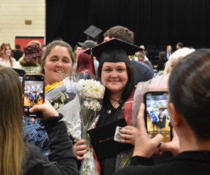 Amy Caton (right) poses for photos at Wiscasset Middle High School after her graduation on Thursday, June 8. Caton was one of 25 students in the class of 2023, who Assistant Principal Warren Cossette said had grown more than any other class in his 30 years of teaching. (Elizabeth Walztoni photo)