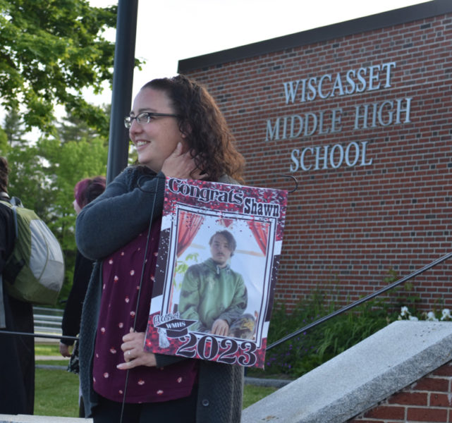 A fan of Wiscasset Middle High School graduate Shawn Jewett stands outside the school after the conclusion of commencement exercises on Thursday, June 8. (Elizabeth Walztoni photo)