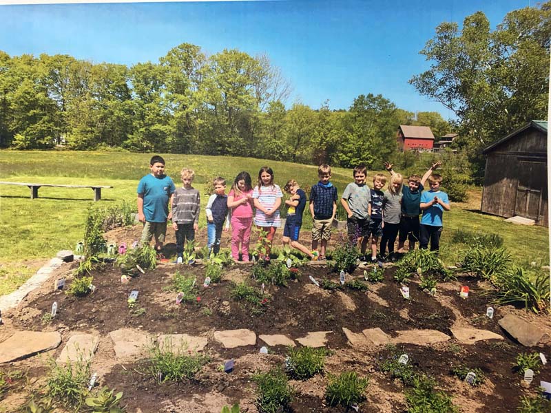 Eddy School students stand with their garden. (Courtesy photo