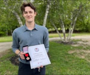 Sam Richards holds his American Red Cross Certificate of Merit. (Photo courtesy The American Red Cross)