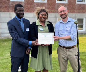 Rodrigue Mwenge and Benedita Kakhuba, of the Brunswick Welcome Center, accept the Community Partner Award from Midcoast Literacy's Executive Director Daniel Burson. (Photo courtesy Bree Candland)