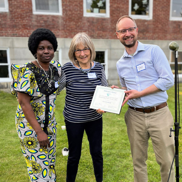 Jen Litchfield, of Topsham, accepts the Outstanding Tutor Award from Midcoast Literacy's Executive Director Daniel Burson alongside learner Jeannette. (Photo courtesy Bree Candland)