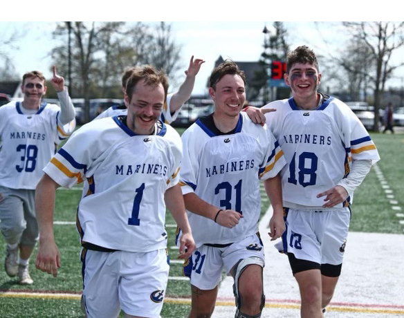 Will Farrell, right, celebrates the North Atlantic Conference victory with Maine Maritime Academy men's lacrosse teammates. (Courtesy photo)