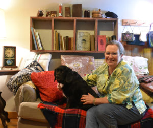 Marilyn Quinn and her dog, Lucy, at Annie Nutbrown, Quinn's new shop in Alna carrying vintage clothing, fabric, sewing supplies, notions, housewares, and more. Quinn said she hopes her wares will inspire customers and become part of their everyday lives. (Elizabeth Walztoni photo)