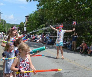 Kids armed with water guns soak Round Pond Fourth of July parade participants, including the Tacky Tourists. (Johnathan Riley photo)