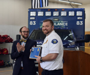 Central Lincoln County Ambulance Service Chief Nicholas Bryant (right) receives the EMS Merit Award from Sam Hurley, director of Maine Emergency Medical Services, on Thursday, June 29. The award is given to seven individuals annually. (Elizabeth Walztoni photo)