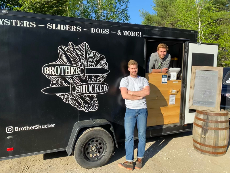 The owners of Brother Shuckers, Hudson Kuras (left) and Zak Kuras, pose outside of their food truck. Brother Shuckers will be one of the regular trucks at Oxbow Brewing Co. in Newcastle this summer. (Photo courtesy Josh Fernands)