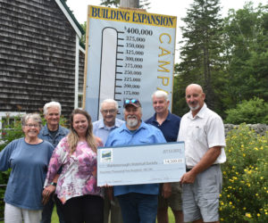 The planning committee for Waldoboro's 250th anniversary celebration presents a check to the Waldoborough Historical Society's capital campaign on Wednesday, July 12, in appreciation for the society's support of the festivities. From left: Jann Minzy, Bob Butler, Jessica Pooley, Bill Blodgett, newly elected society President Bill Maxwell, Seth Blodgett, and John Blodgett. (Elizabeth Walztoni photo)