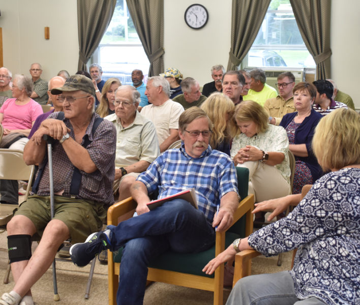 Wiscasset residents crowd the municipal building meeting room on Tuesday, July 18 before the select board's review of a business license application by Amistad Inc. for a recovery center at St. Philip's Episcopal Church. After an hour and a half of emotional public comment, board members voted to table the application for two months, citing concerns about the details of the plan, communication from both organizations, and a lack of trust in Amistad. (Elizabeth Walztoni photo)