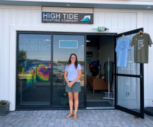 Kate Bell stands in front of her High Tide Printing Co. storefront in Wiscasset. Bell opened the screenprinting shop in mid-June. (Frida Hennig photo)