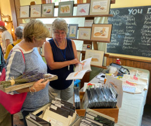 Shoppers browse at a previous arts fair in the Washington Schoolhouse. (Photo courtesy Round Pond Schoolhouse Association)